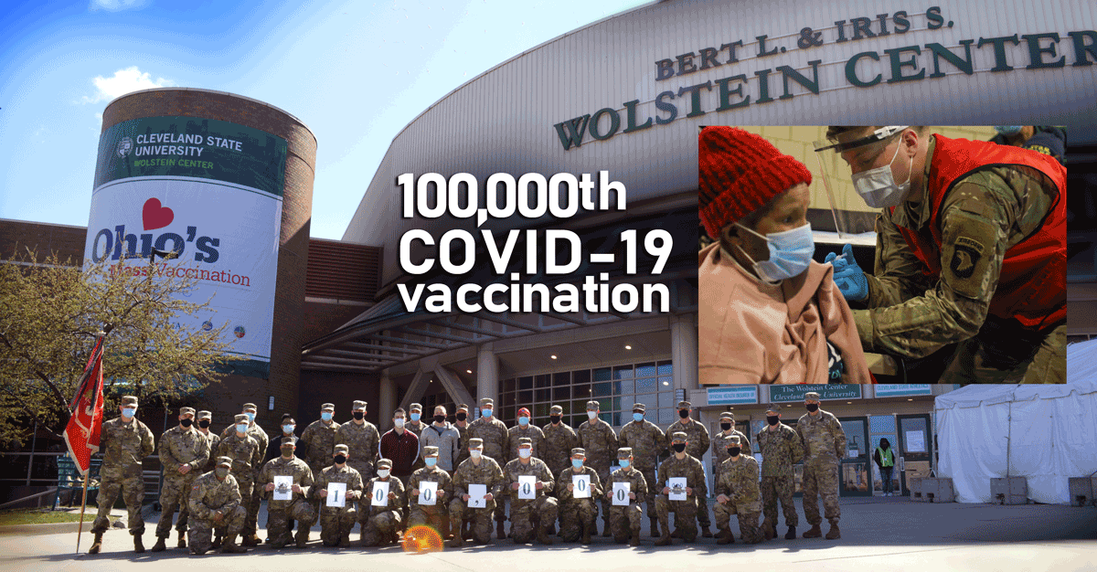 Soldiers and Airmen stand for group shot in front of Auditorium, with super-imposed image of 100,000th recipient getting their shot.