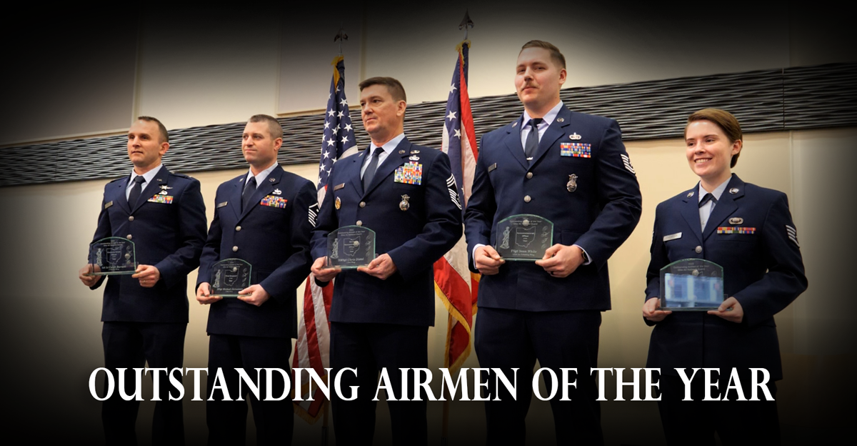 Five airmen stand with awards.