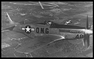 A pilot from the 162nd Fighter Squadron flies a F-51 Mustang somewhere over Ohio, circa 1940s.