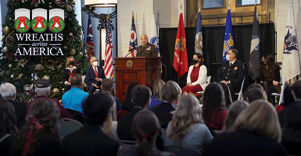 Leadership at State house with Maj. Gen Harris at podium.