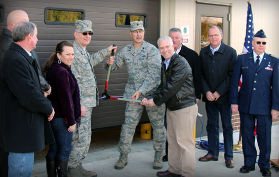 U.S. Rep. Bill Johnson (fourth from right), from Ohio's 6th Congressional District, helps Brig. Gen. Mark Stephens (fourth from left), director of joint staff for the Ohio National Guard, and Lt. Col. Robert Panian (fifth from left), commander of the 220th Engineering Installation Squadron, cut the ceremonial ribbon March 23, 2013, to open the 220th EIS's new supply warehouse in Zanesville, Ohio.