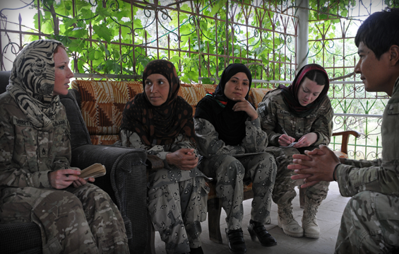 During a shura April 21, 2012, in Haritan, Balkh province, Afghanistan, Barrett and Barnhill speak with two female Afghan Border Police through their language assistant. 