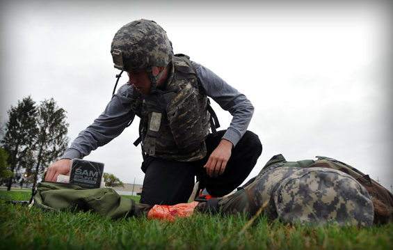 A Soldier with the 371st Special Troops Battalion applies a tourniquet to the arm of Pfc. Kelly Franz, a combat medic for the 285th Medical Company (Area Support) out of Columbus, Ohio, as part of the 371st Soldier of the Year competition Sept. 9, 2012, at the Defense Supply Center Columbus in Columbus, Ohio.