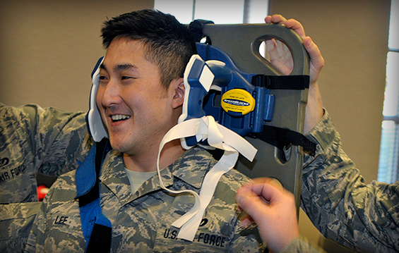 Staff Sgt. Danny Lee, a firefighter with the 178th Fighter Wing, is placed in an immobilizing brace during hands-on emergency medical technician training.