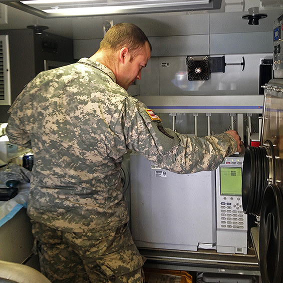 Sgt. 1st Class Ross Miller, a medical noncommissioned officer for the 52nd Civil Support Team, runs water samples.