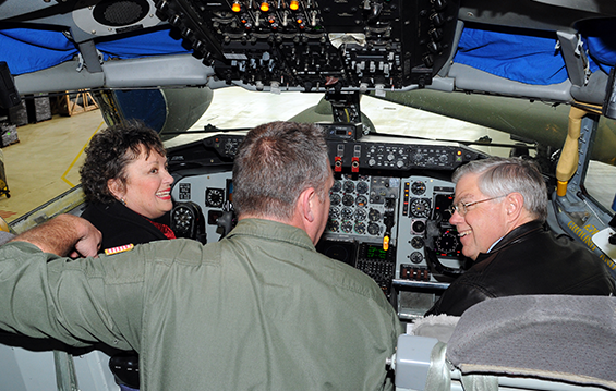 Lt. Col. Troy Smith (center), a KC-135R Stratotanker pilot instructor with the 121st Air Refueling Wing, answers questions from state Reps. Cheryl Grossman (left) and Gary Scherer (right), while in the cockpit of a KC-135R 