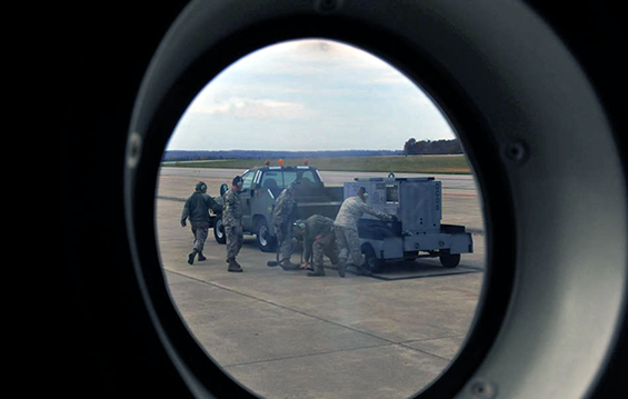 A view from the porthole window of a C-130H Hercules cargo aircraft 