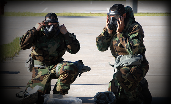 Master Sgt. Seth Skidmore (left) and Tech. Sgt. Lou Burton of the 178th Fighter Wing don their protective masks during training 