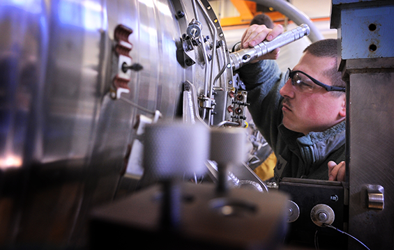 Tech Sgt. Nick Skolmowski, a jet engine mechanic with the 180th Fighter Wing, inspects a Pratt and Whitney 229 engine 