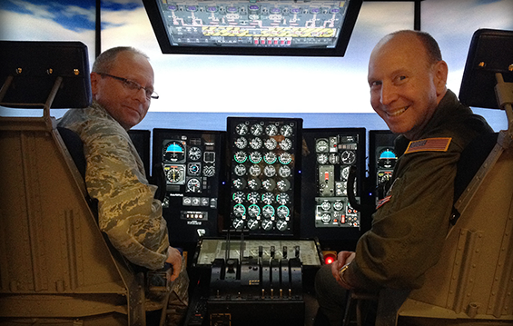 Col. James Jones, commander of the 121st Air Refueling Wing, and Col. Mark Auer, 179th Operations Group commander, check the progress of the programming installed on the Air National Guard's first Multi-Mission Crew Trainer.