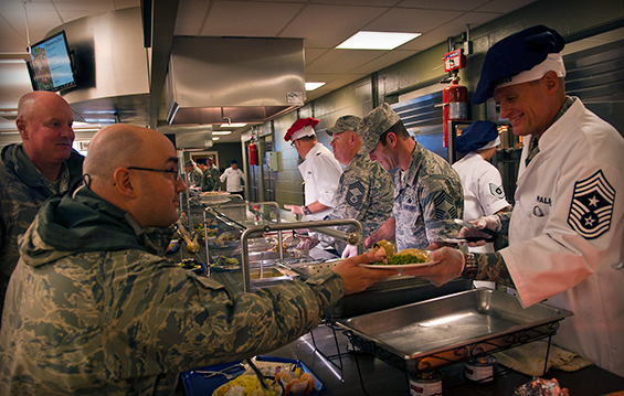 Senior leaders at the 121st Air Refueling Wing serve a holiday meal to Airmen at the Red Tail Dining Facility.