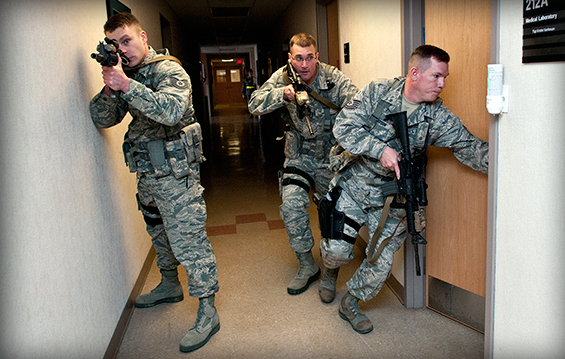Tech. Sgts. Steve Thompson (from left), Gregory Oberfield and Brandon Ostrowsky, of the 121st Security Forces Squadron, perform close quarter search and clear maneuvers in response to a simulated active shooter during a training exercise.