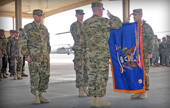 Command Sgt. Maj. William Adams (second from right) and Lt. Col. Pat Durbin, commander of 1st Battalion, 137th Aviation Regiment, salute during a transfer of authority ceremony .