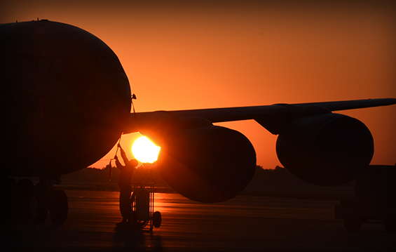 An Airman with the 121st Air Refueling Wing removes the pitot tube cover on a KC-135 Stratotanker at sunrise.