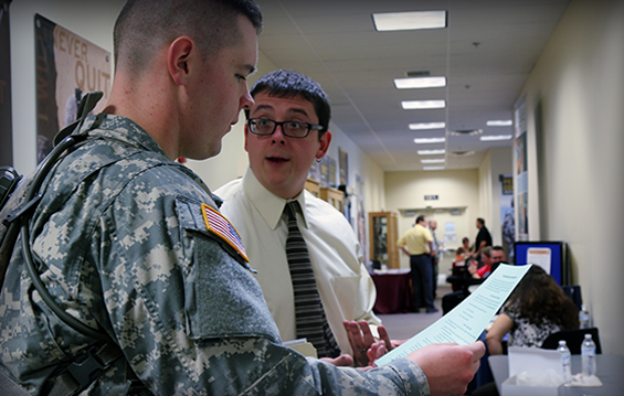 Pfc. Caleb M. Breshears (left), a Heath, Ohio native and a motor transport operator with Headquarters and Headquarters Company, 16th Engineering Brigade, speaks with Joshua Rider, director of the Center for Adult and Veteran Services at Kent State University.