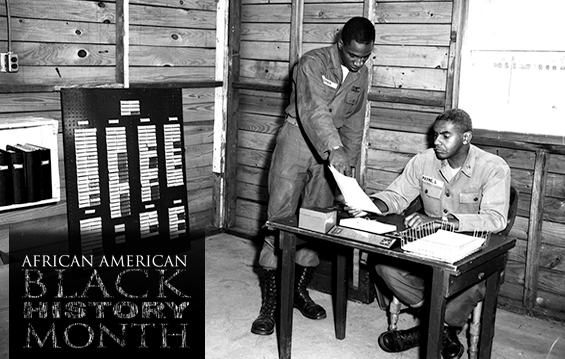 Pvt. Lipkin (left) shows paperwork to Capt. James B. Payne in an office at Camp Perry, near Port Clinton Ohio, circa 1950s. 