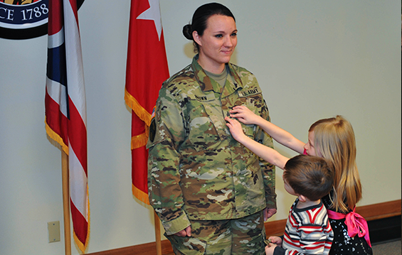 Sgt. 1st Class Jennifer Brown is “pinned” by her children.