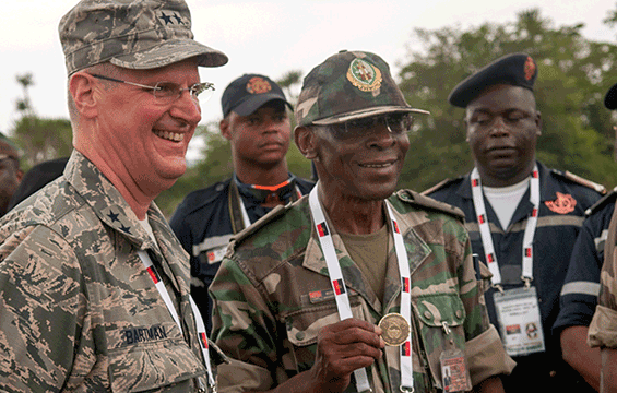 Maj. Gen. Mark E. Bartman (left), Ohio adjutant general, gives one of his coins to Brig. Gen. Jose Belchior da Silva of the Angolan Armed Force.