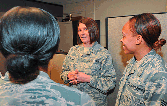 Senior Master Sgt. Kari Nettle (center), the state personnel superintendent for the Ohio Air National Guard at Joint Force Headquarters, talks with other Airmen from her office.