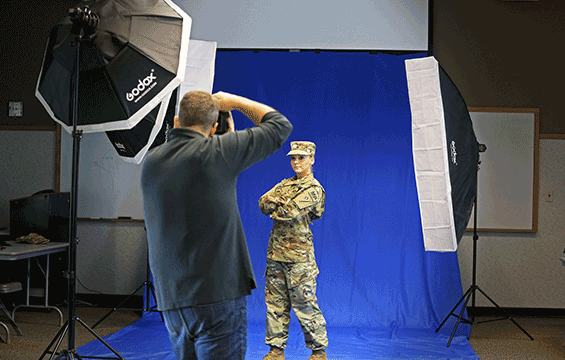 Bradley Logan of the Strength Readiness Support Center photographs Spc. Jennifer Seidl, a Soldier with the 585th Military Police Company.