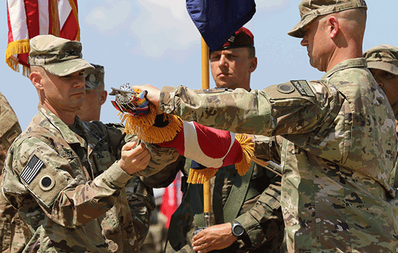 Col. Corwin Lusk and Command Sgt. Maj. Jeffrey Schuster, command team of the 37th Infantry Brigade Combat Team, case the colors during the KFOR Multinational Battle Group-East Transfer of Authority ceremony.