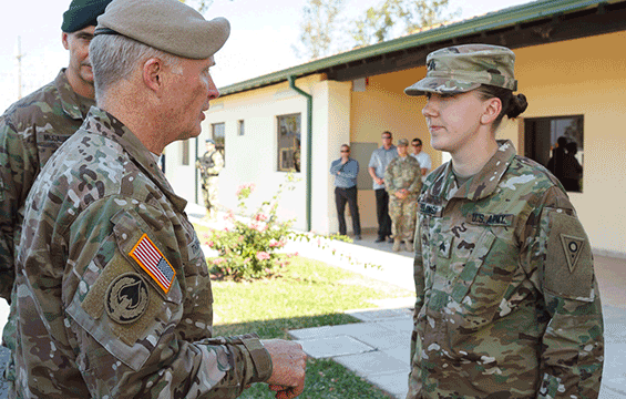Sgt. Hannah Selinsky (right), a broadcast sergeant with the 196th Mobile Public Affairs Detachment, is recognized for her work by Gen. Raymond A. Thomas III, commander of U.S. Special Operations Command.