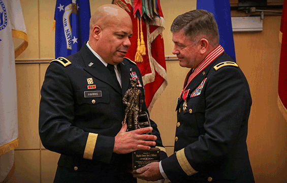 Maj. Gen. John C. Harris Jr., Ohio assistant adjutant general for Army, presents Brig. Gen. Dana L. McDaniel with a National Guard minuteman statue.