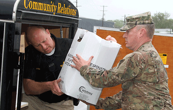 Maj. Matthew Toomey (right), operations officer for the Ohio National Guard Counterdrug Task Force works alongside local law enforcement personnel to collect boxes of unwanted prescription drugs.