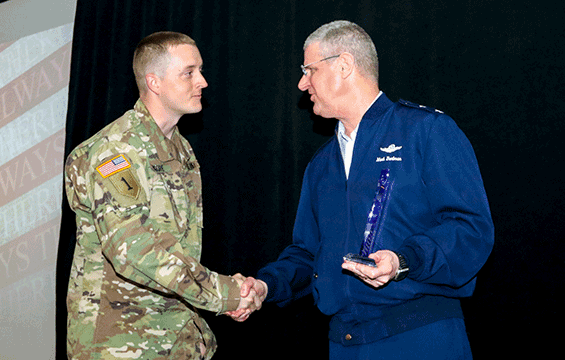 Maj. Gen. Mark E. Bartman, Ohio adjutant general, presents Maj. Kyle Moore, operations officer for the 112th Engineer Battalion, with the Maj. Gen. Gregory L. Wayt Visionary Leadership Award.