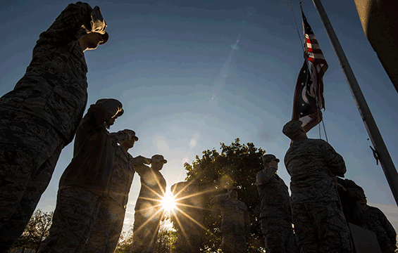 Airmen of the 121st Air Refueling Wing raise the flag just after sunrise.