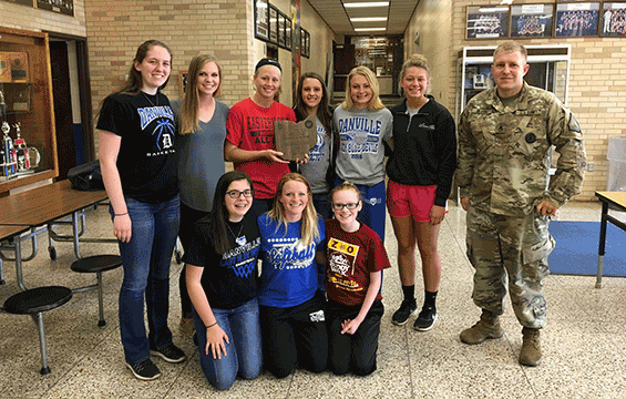 Staff Sgt. Justin Delong, of the Ohio Army National Guard Recruiting and Retention Battalion, presents an award to members of the Danville High School girls basketball team.