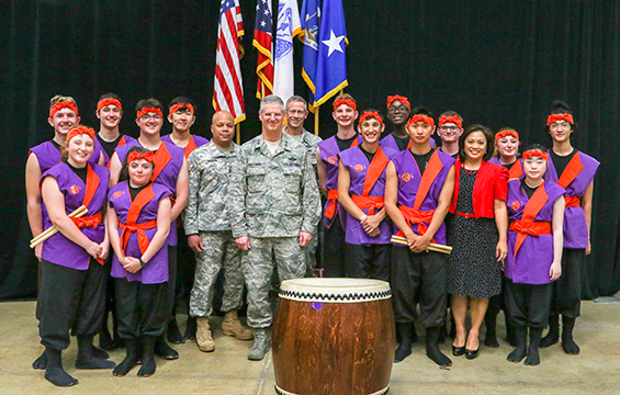 Maj. Gen. John C. Harris Jr. (center, from left), Ohio assistant adjutant general for Army, Maj. Gen. Mark E. Bartman, Ohio adjutant general, and Brig. Gen. Gregory N. Schnulo, assistant adjutant general for Air, stand for a photo with television news reporter/anchor Angela An (fourth from right) and members of the Dublin Taiko Group, a Japanese drum ensemble from Dublin City Schools.