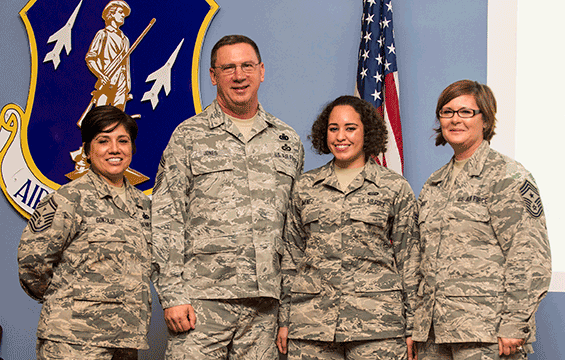 Chief Master Sgt. Thomas Jones recognizes Airmen of the 121st Air Refueling Wing with challenge coins: Senior Master Sgt. Tamara Gonzalez, Staff Sgt. Sabrina Jimenez and Chief Master Sgt. Kelly A. Gibbs. 