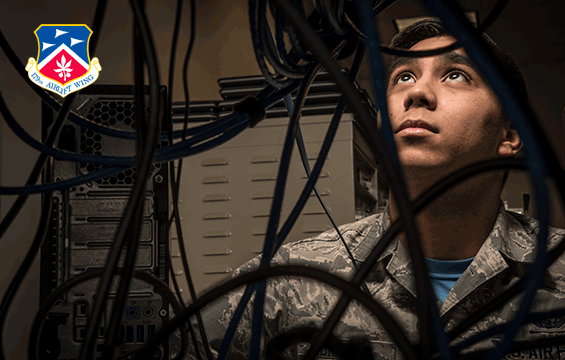 Airman Brown with network cables in front of him.