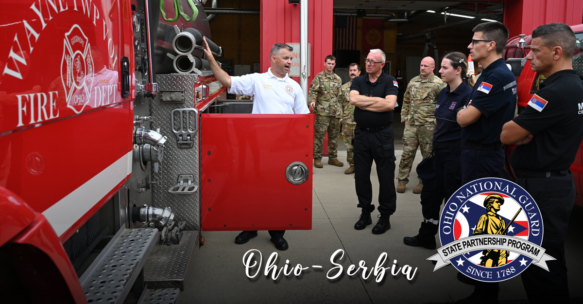 Serbian firefighters look at firetruck