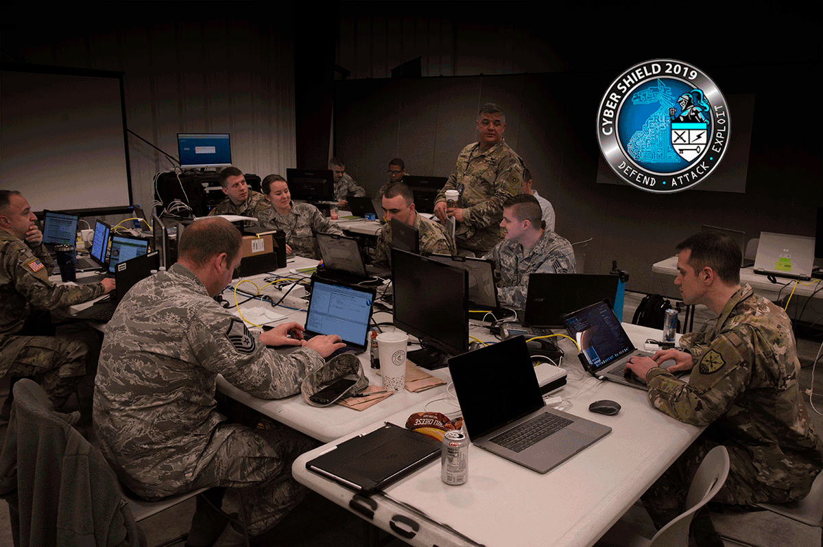 A team of 10 Ohio National Guard cyber warriors sit in classroom with laptops at tables to participate in a pilot program.