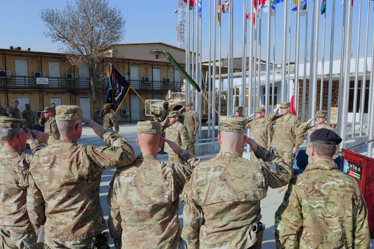 U.S. and Coalition Forces service members salute the colors during a transfer of authority ceremony held at Camp Eggers, Afghanistan. 