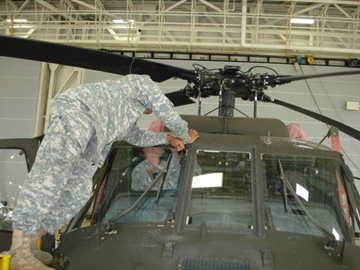 Soldiers from the Ohio Army National Guard’s Company D, 1st Battalion, 137th Aviation Regiment, perform maintenance on a UH-60 Black Hawk helicopter June 17, 2011, in Akron, Ohio. The Downed Aircraft Recovery Team, or DART, from Company D repaired and recovered the aircraft, which was forced to make a precautionary landing in a cornfield near Akron. 