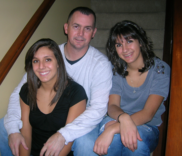 Ohio Army National Guard 1st Sgt. Chad Savage (center) poses with his daughters, Taylor (left) and Tia.