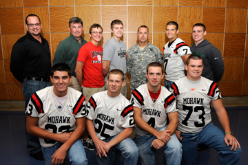 Maj. Brett Graham (back row, fifth from left) of Headquarters Company, 37th Infantry Brigade Combat Team, stands with students of Mohawk High School, located in Sycamore