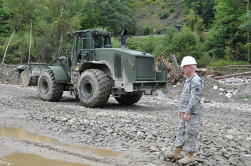 First Lt. Timothy Sutter, a member of the 1191st Engineer Company and Batavia, Ohio, resident, supervises Vermont and Ohio National Guard engineers as they work to repair a bridge washed out by Tropical Storm Irene floodwaters on Vermont Route 131 in Cavendish, Vt.