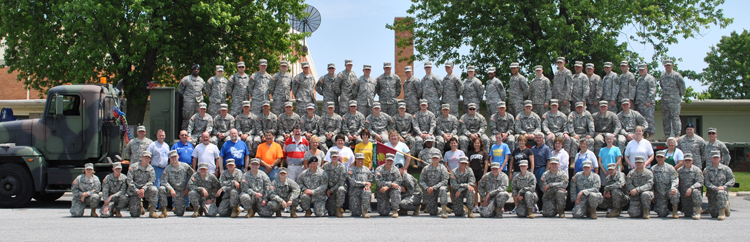 Soldiers from the Piqua-based 1487th Transportation Company, Ohio Army National Guard, gather with faculty from Miami East High School June 11, 2011, in Casstown, Ohio, after helping to move school equipment into the school’s brand new facility