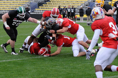 South All-Star defenders tackle a North running back.
