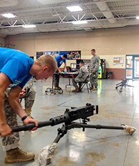 Ohio Army National Guard Spc. Matthew T. Richardson completes the M2A1 clear-disassemble-functions check station.