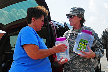 Maj. Gen. Deborah A. Ashenhurst, Ohio adjutant general hands out fresh water to local resident.