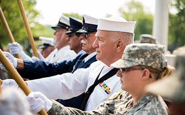 Current and retired service members comprise the color guard.