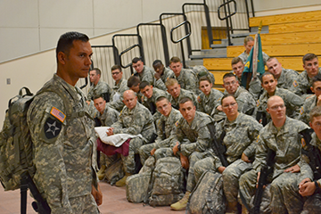First Sgt. Grant Burtch (left, standing), and Soldiers assigned to the 324th Military Police Company listen to the farewell brief.