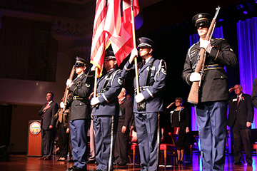 Members of a multiservice color guard post the colors. 