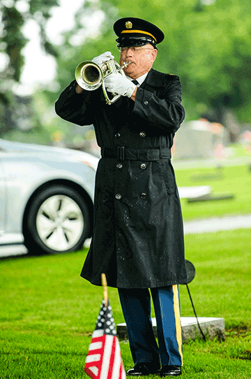 A bugler from the Ohio Army National Guard Military Funeral Honors Team plays taps during graveside services for Technician 4th Grade John Kovach Jr. 