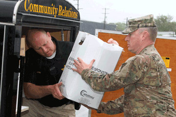 Maj. Matthew Toomey (right), operations officer for the Ohio National Guard Counterdrug Task Force works alongside local law enforcement personnel to collect boxes of unwanted prescription drugs.